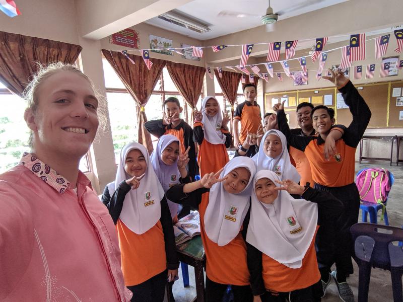 Griffin Kammerer, left, with his seventh-grade students in Sabah, Malaysia. Kammerer is wearing a batik, which is formal Malaysian attire that all male teachers wear to school on Thursdays. SUBMITTED PHOTOS